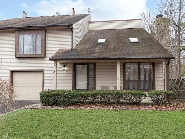 view of front of property featuring a garage and a front lawn