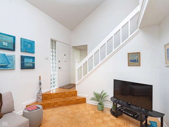 entrance foyer with parquet floors and a textured ceiling