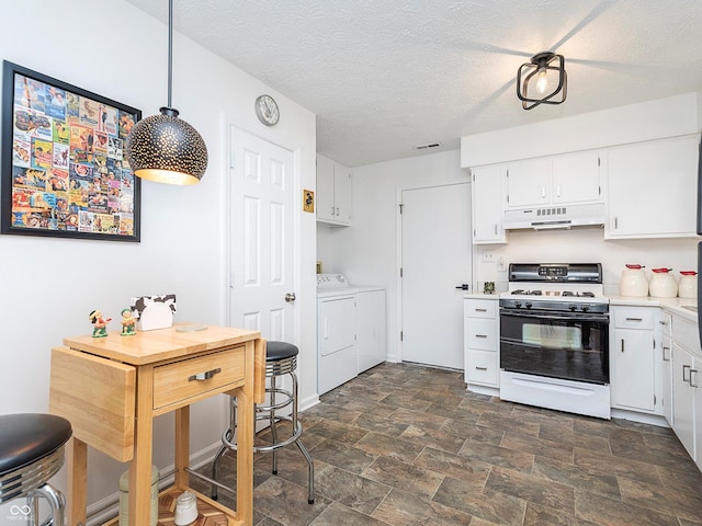 kitchen with separate washer and dryer, pendant lighting, white cabinets, and gas range oven