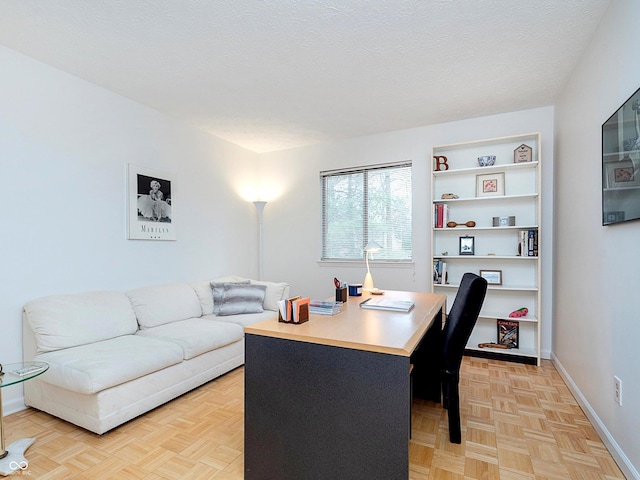 office area featuring light parquet flooring and a textured ceiling