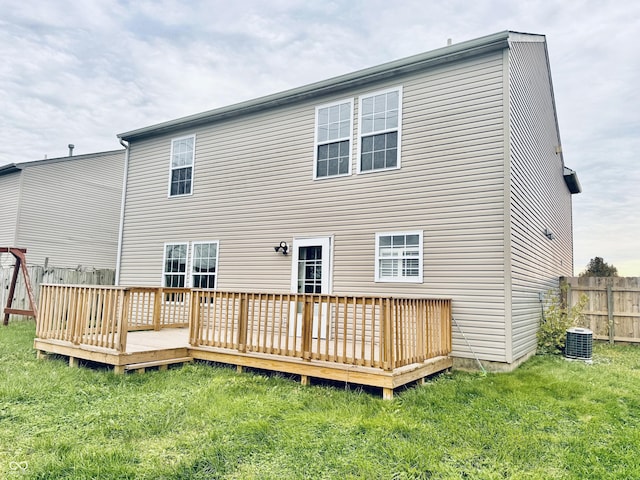 rear view of house with a wooden deck, a lawn, and central air condition unit