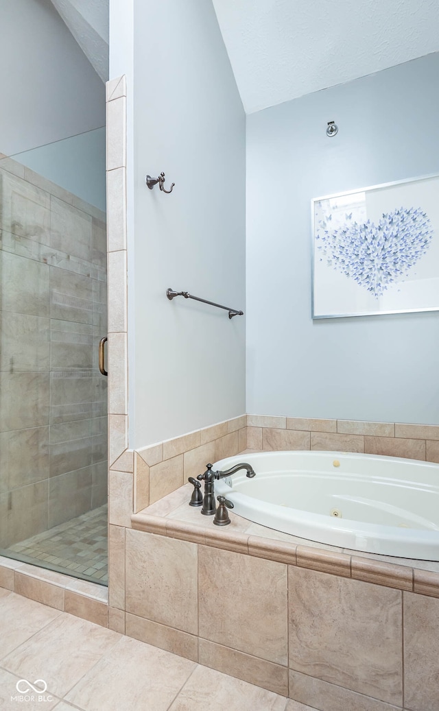 bathroom with tile patterned floors and independent shower and bath