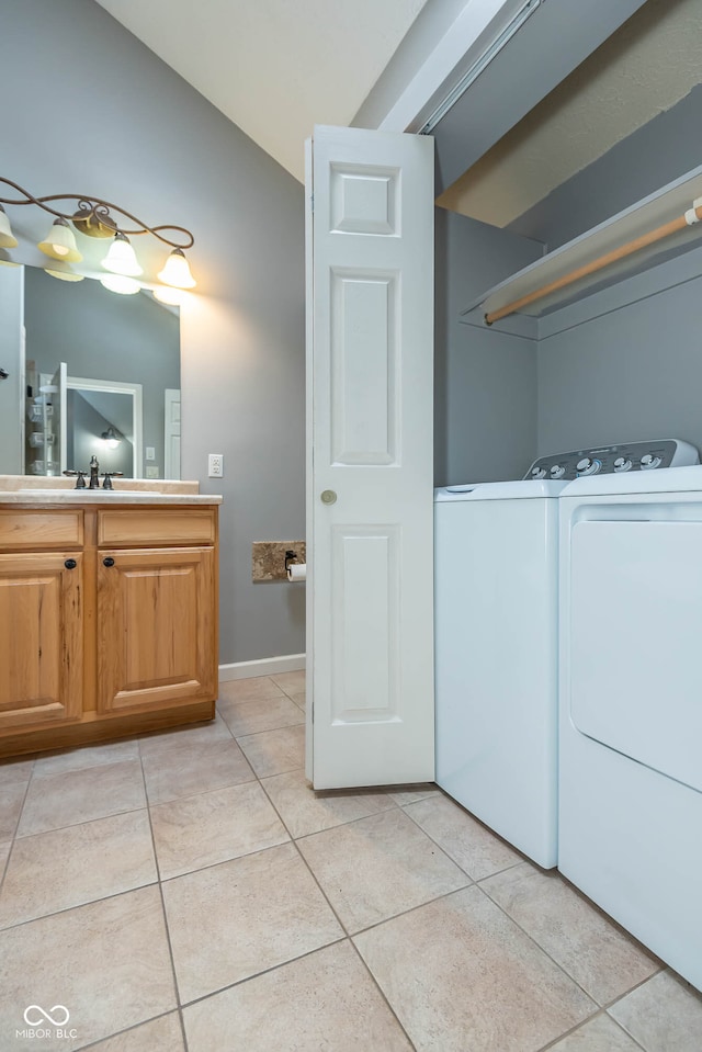 interior space featuring light tile patterned floors, sink, and independent washer and dryer