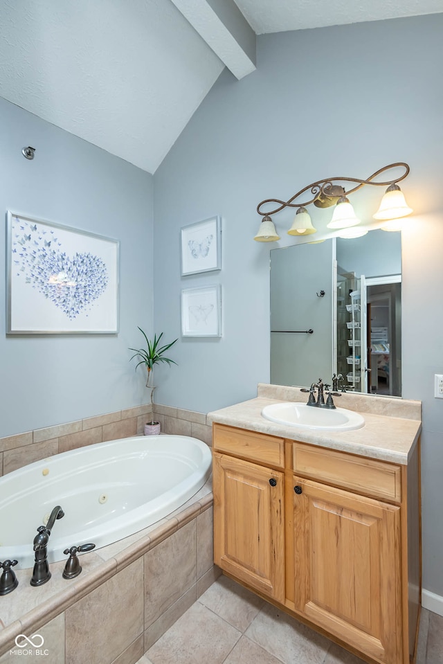 bathroom with tiled tub, vanity, vaulted ceiling with beams, and tile patterned floors