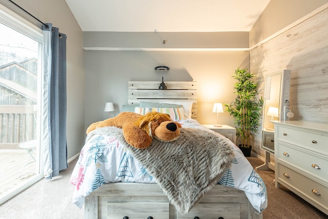 bedroom featuring vaulted ceiling and carpet