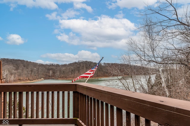 wooden terrace featuring a water view