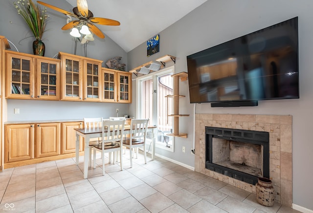 kitchen with light tile patterned flooring, ceiling fan, and vaulted ceiling