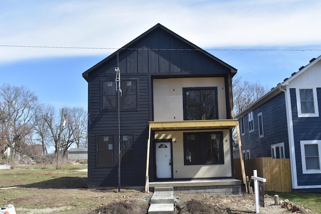 view of front of home with covered porch and fence