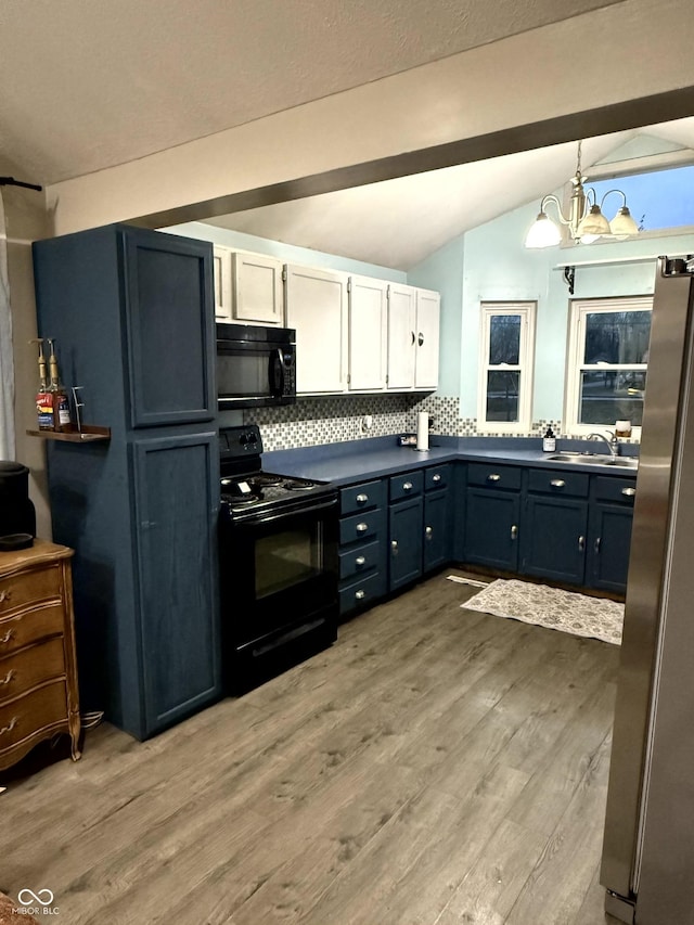 kitchen with vaulted ceiling with beams, white cabinets, hanging light fixtures, light hardwood / wood-style floors, and black appliances