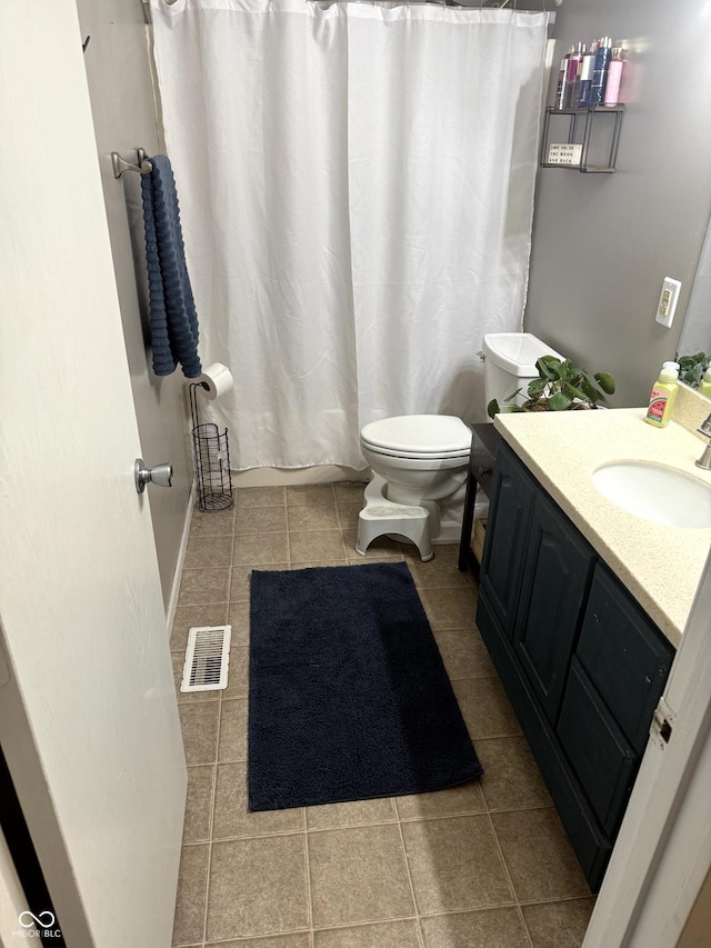 bathroom with vanity, tile patterned floors, and toilet