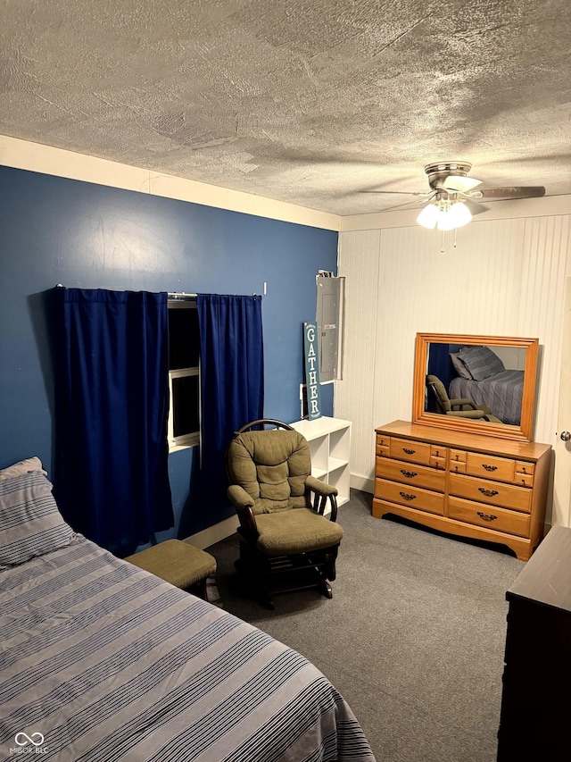 bedroom featuring ceiling fan, carpet floors, and a textured ceiling