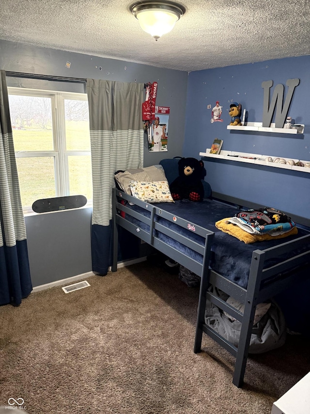 carpeted bedroom featuring a textured ceiling