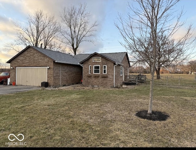 view of front of property with a garage and a lawn