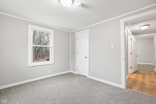 unfurnished bedroom featuring ornamental molding and carpet flooring