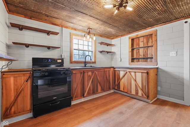 kitchen featuring wood ceiling, black range with gas cooktop, sink, and light hardwood / wood-style flooring