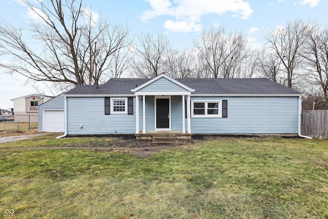 view of front of house featuring a garage and a front lawn