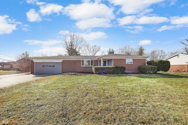 ranch-style house with a garage and a front lawn