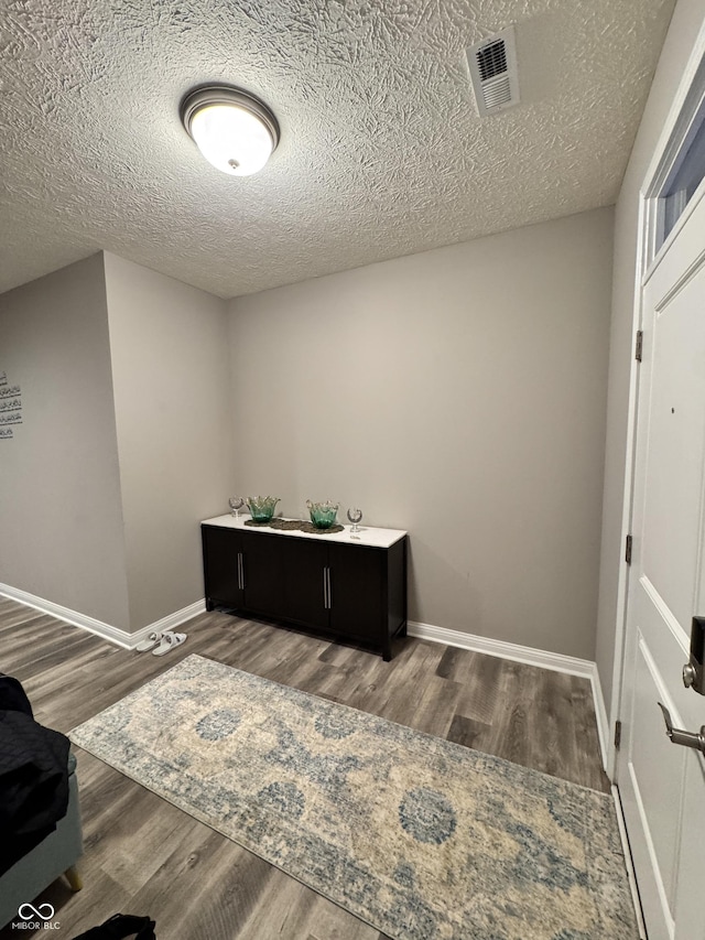 entrance foyer featuring dark hardwood / wood-style floors and a textured ceiling