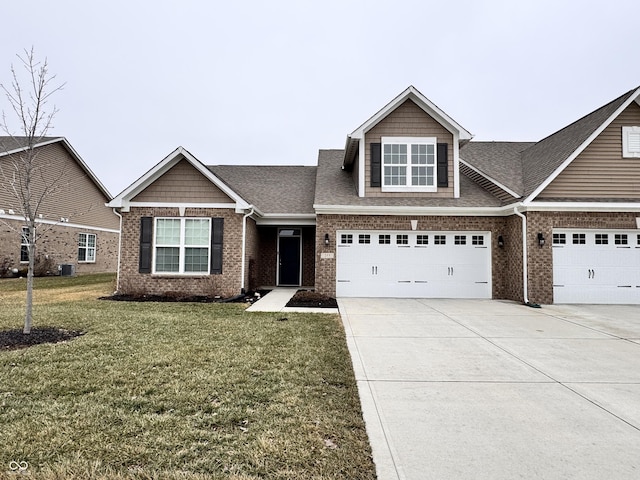 view of front of house with a garage and a front lawn