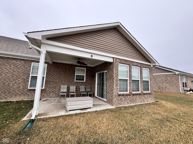 back of property featuring ceiling fan, a yard, and a patio