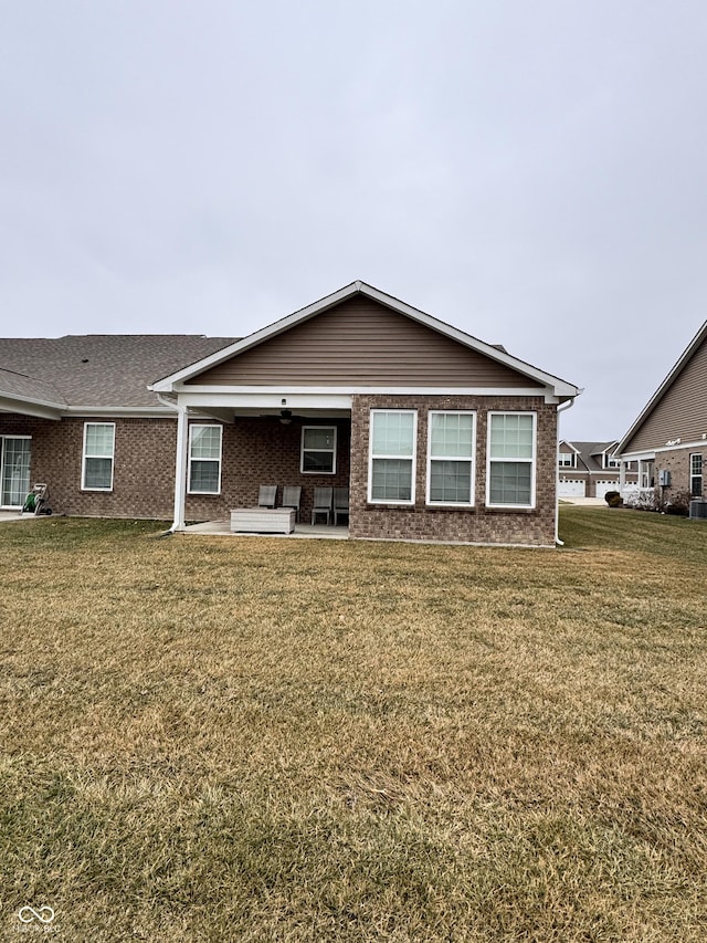 view of front of house with a front yard and a patio