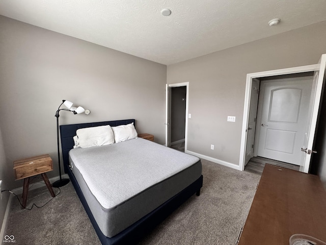 carpeted bedroom featuring a textured ceiling