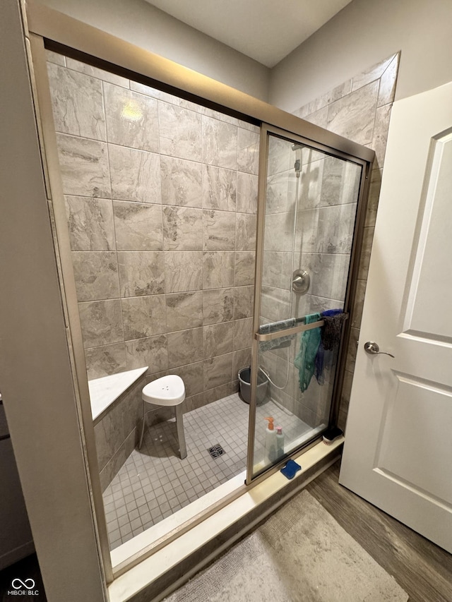 bathroom featuring an enclosed shower and hardwood / wood-style floors