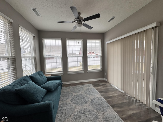 sitting room featuring dark hardwood / wood-style floors and a textured ceiling