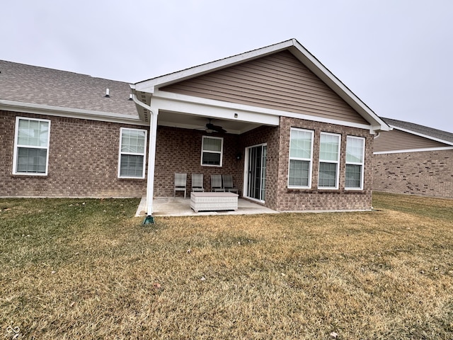 back of property with a lawn, a patio, and ceiling fan