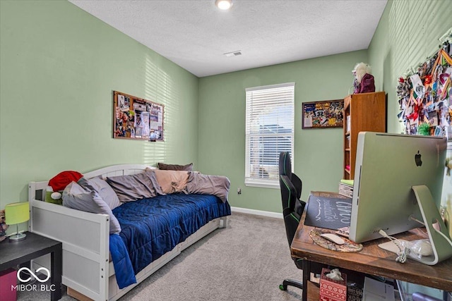 bedroom with a textured ceiling, carpet floors, visible vents, and baseboards