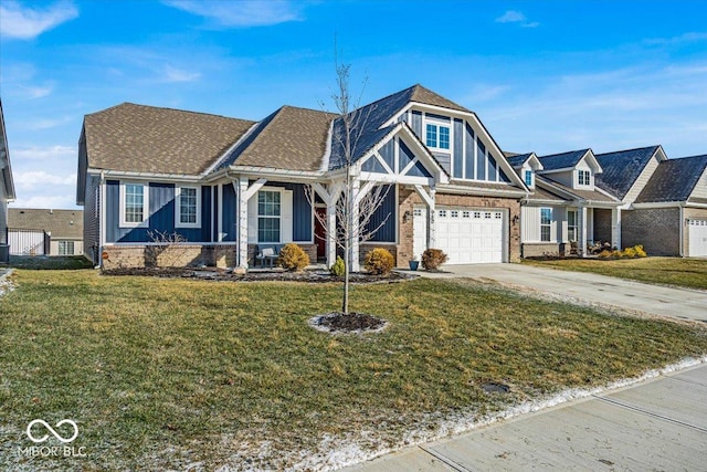 view of front of house with driveway, a front lawn, an attached garage, and brick siding