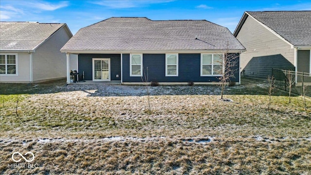 back of house featuring a patio area, a shingled roof, and fence