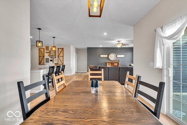 dining room featuring ceiling fan, a textured ceiling, recessed lighting, wood finished floors, and baseboards