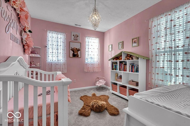 bedroom featuring a textured ceiling, a notable chandelier, carpet floors, visible vents, and baseboards