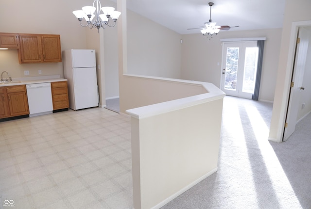 kitchen with white appliances, a chandelier, sink, and hanging light fixtures