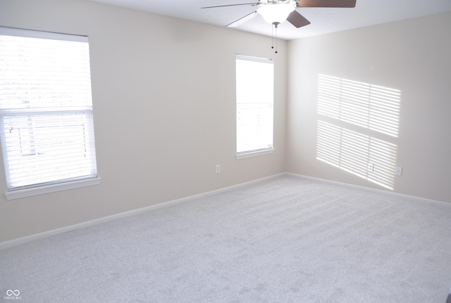 spare room with carpet flooring and ceiling fan