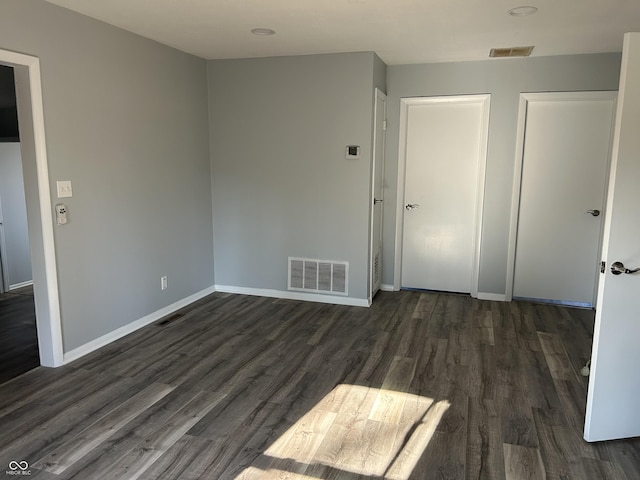 unfurnished room featuring dark hardwood / wood-style flooring