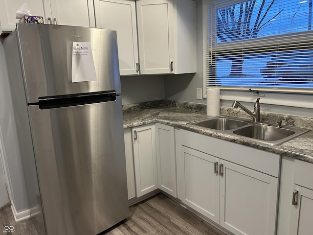 kitchen with white cabinetry, stainless steel fridge, sink, and dark wood-type flooring