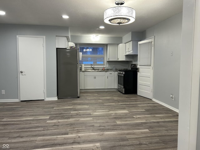 kitchen featuring white cabinetry, appliances with stainless steel finishes, sink, and dark wood-type flooring