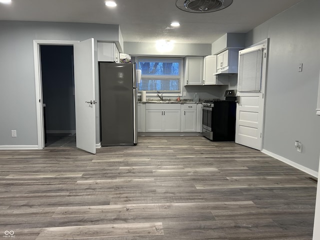 kitchen with white cabinetry, sink, hardwood / wood-style flooring, and stainless steel appliances