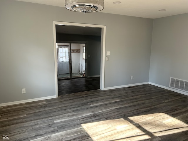 unfurnished room with dark hardwood / wood-style floors