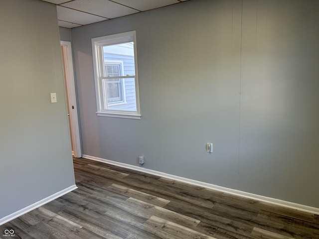 empty room featuring hardwood / wood-style floors and a drop ceiling