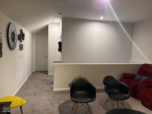 sitting room featuring lofted ceiling, carpet floors, and baseboards