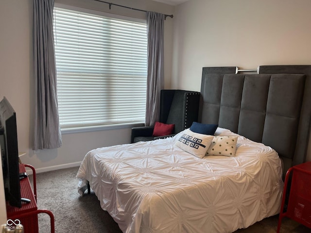 bedroom featuring carpet floors and baseboards