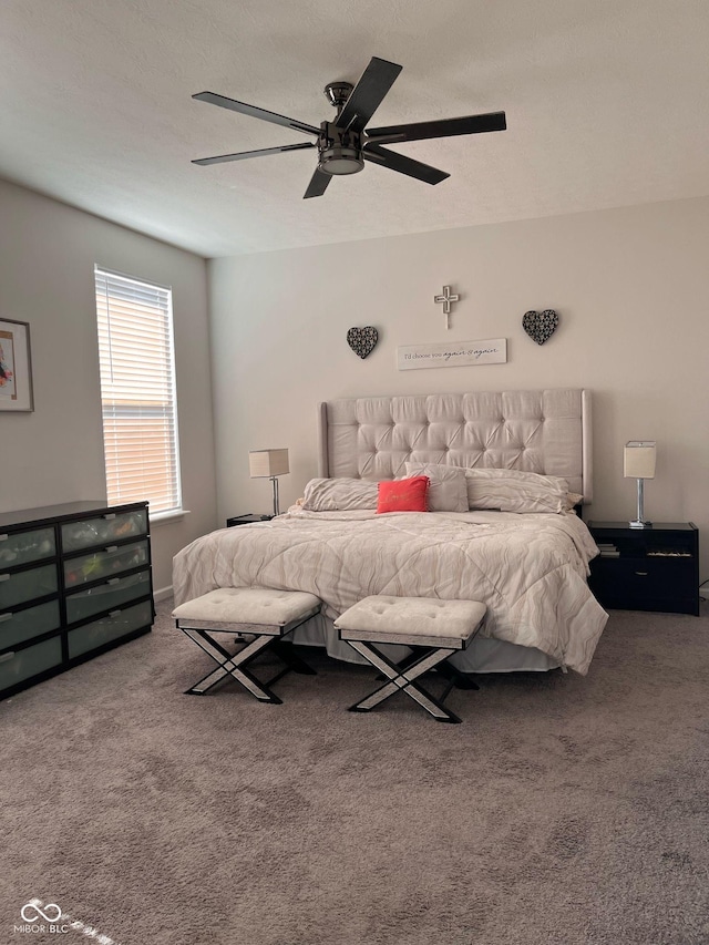 bedroom with carpet, ceiling fan, and a textured ceiling