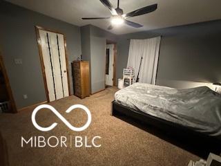 bedroom featuring ceiling fan and light colored carpet