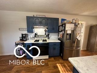 kitchen with dark hardwood / wood-style floors, blue cabinets, stainless steel fridge, and white range with gas cooktop