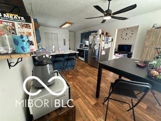 interior space with stainless steel fridge with ice dispenser, dark hardwood / wood-style floors, and ceiling fan