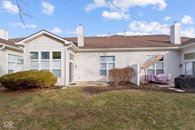 back of property with a patio and a lawn