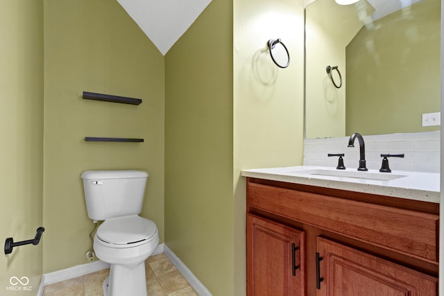 bathroom featuring tile patterned flooring, backsplash, vanity, vaulted ceiling, and toilet